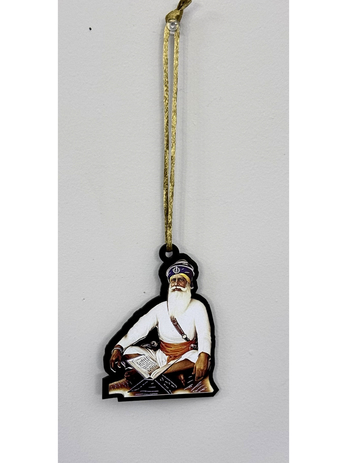 Car hanging with a gold cord and a religious portrait